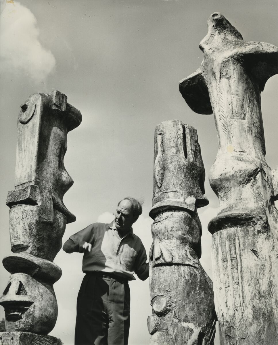 Henry Moore with three of his Upright Motives, circa 1955 Courtesy The Henry Moore Foundation Photo by Barry Warner.jpg