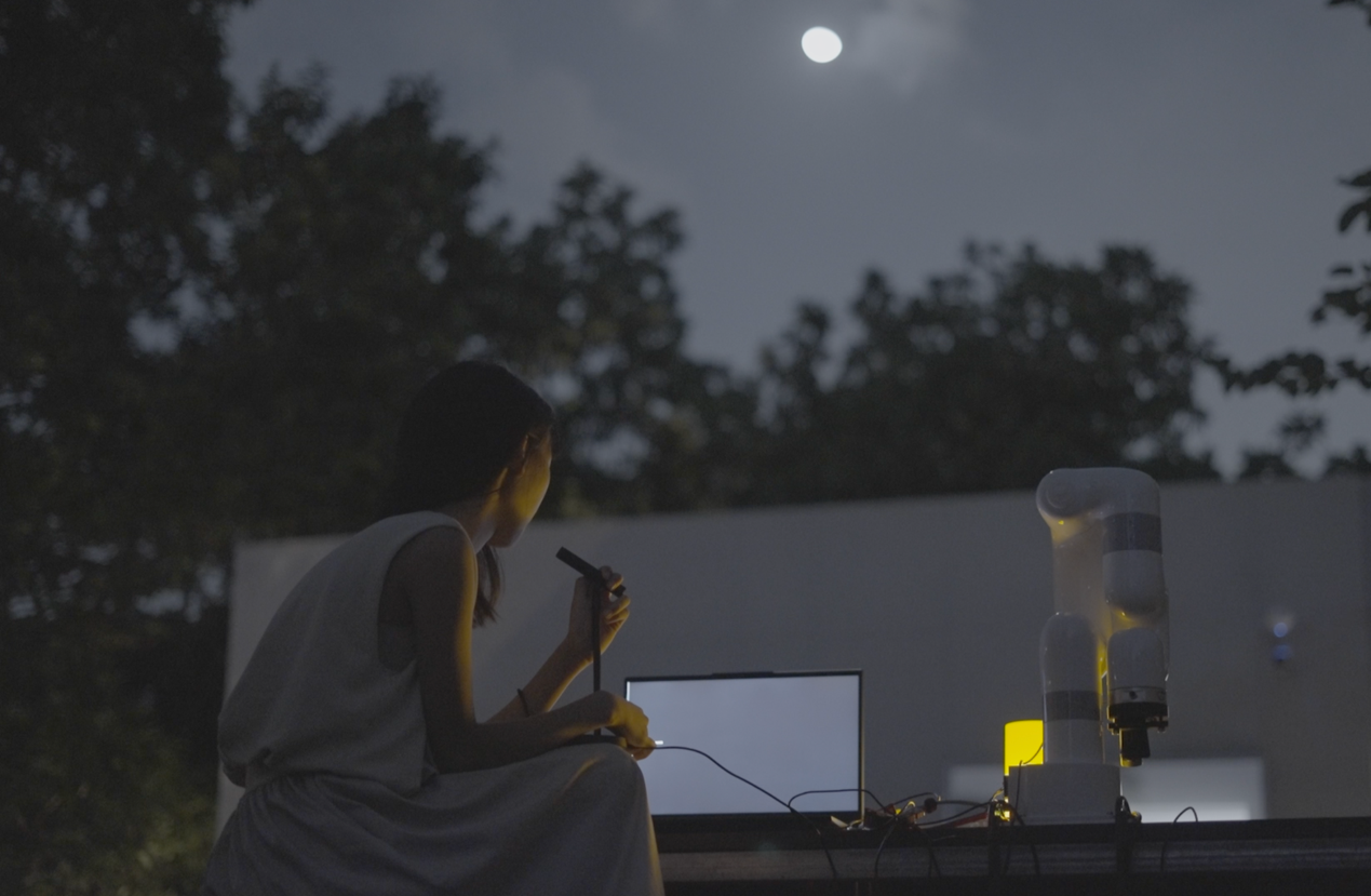 Zoe Li, I Tell the Moon My Secret and the Moon Tells Me Yours, 2021, interacting with the moon outdoors, robotic arm, moon, photographs, video, dimension variable. Image courtesy of the artist.png